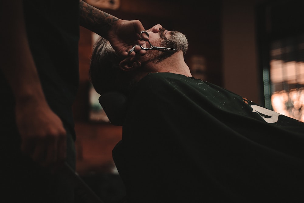 A barber working on a client
